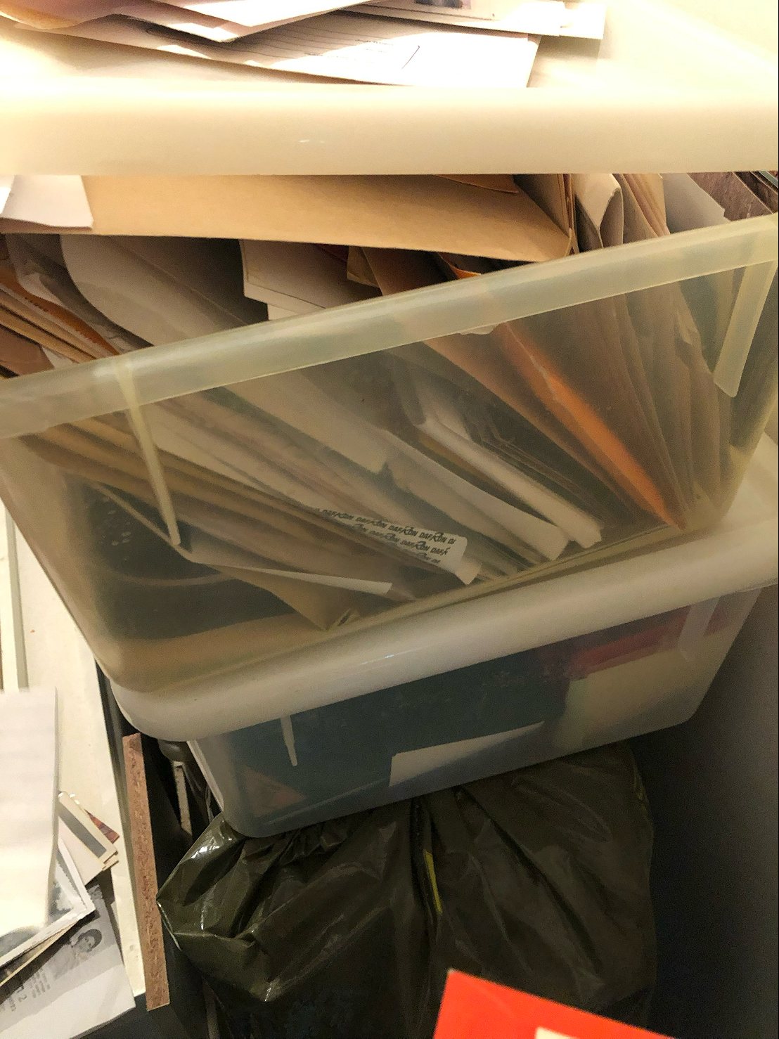 A plastic box full of envelopes and documents
