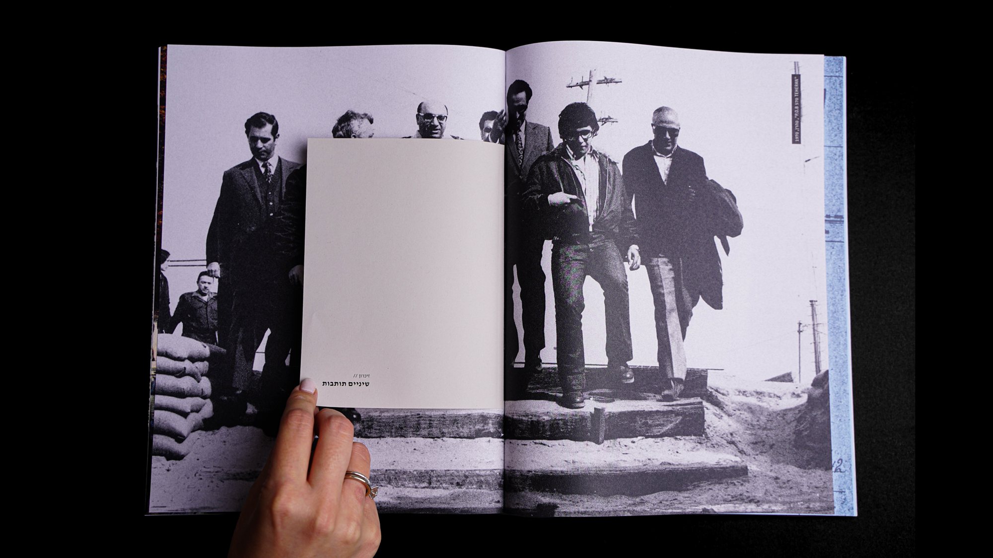 A spread with a folded page over a group photo of agents