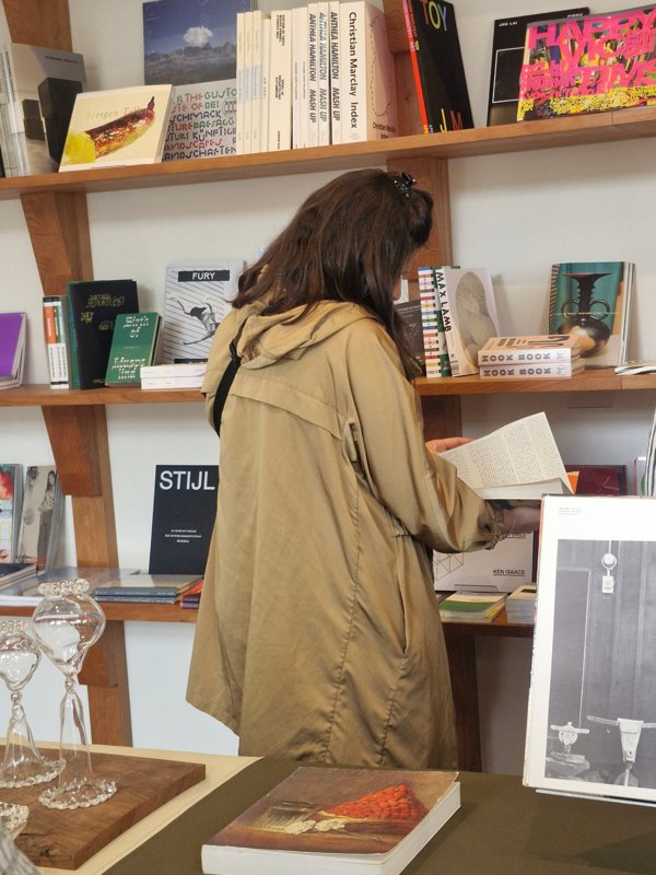 Netta browsing art books in a bookshop